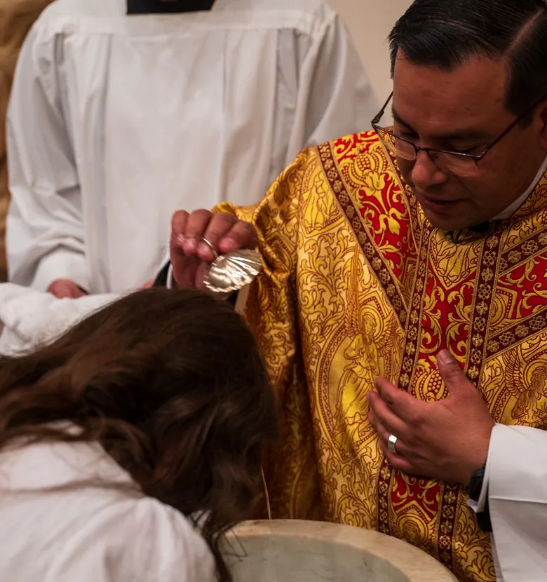 an adult being baptized at the font